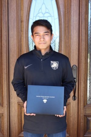 Senior Pai holding his West Point appointment letter